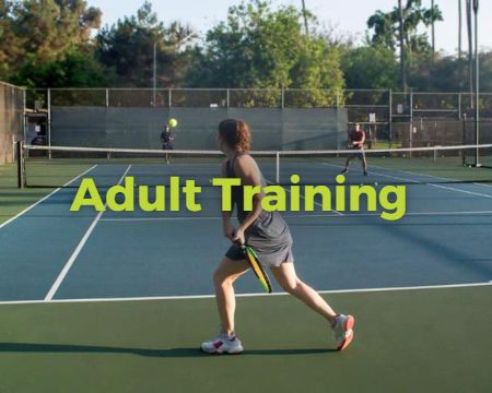 Adults playing tennis, mixed doubles